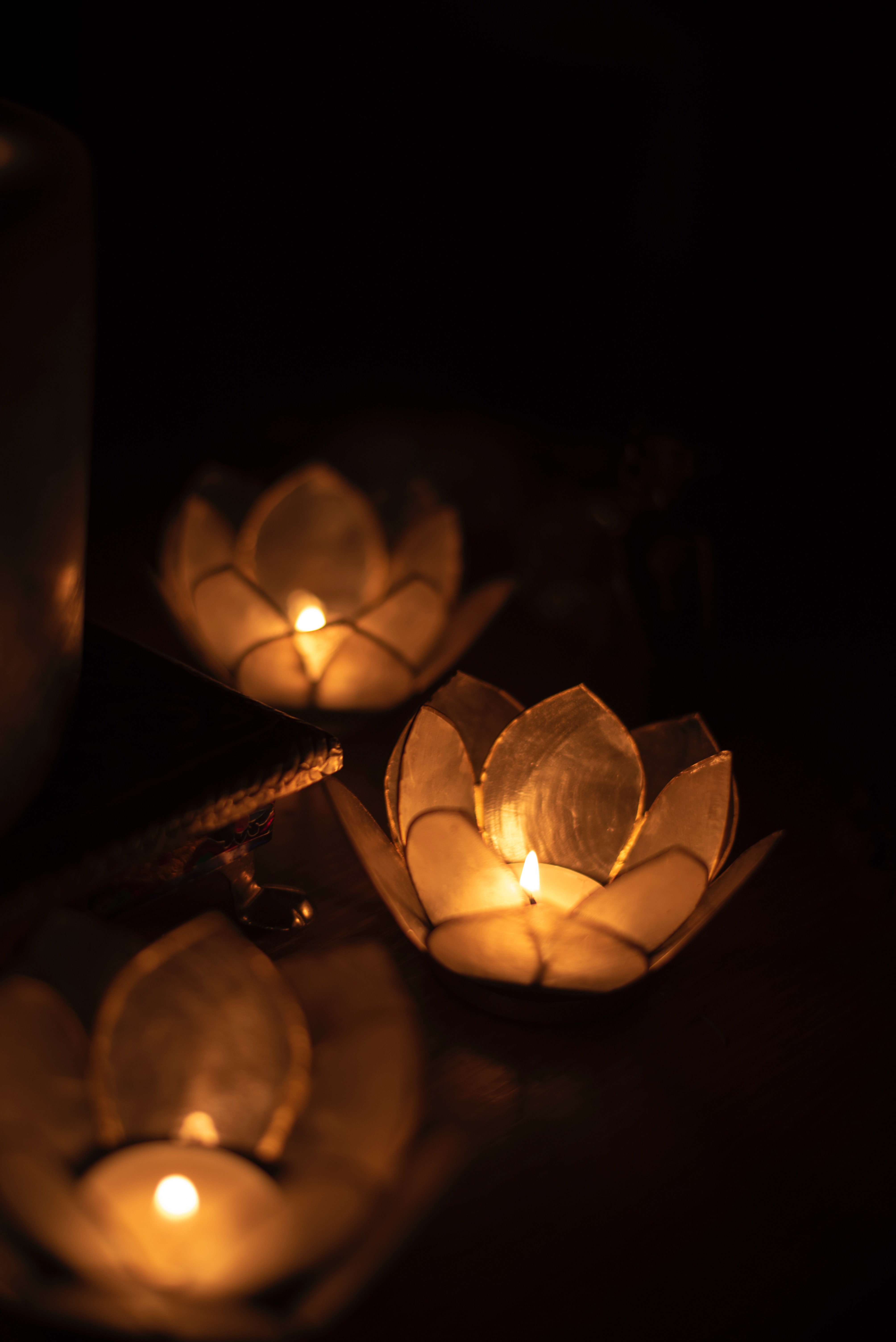 3 lotus-flower shaped candles in the dark